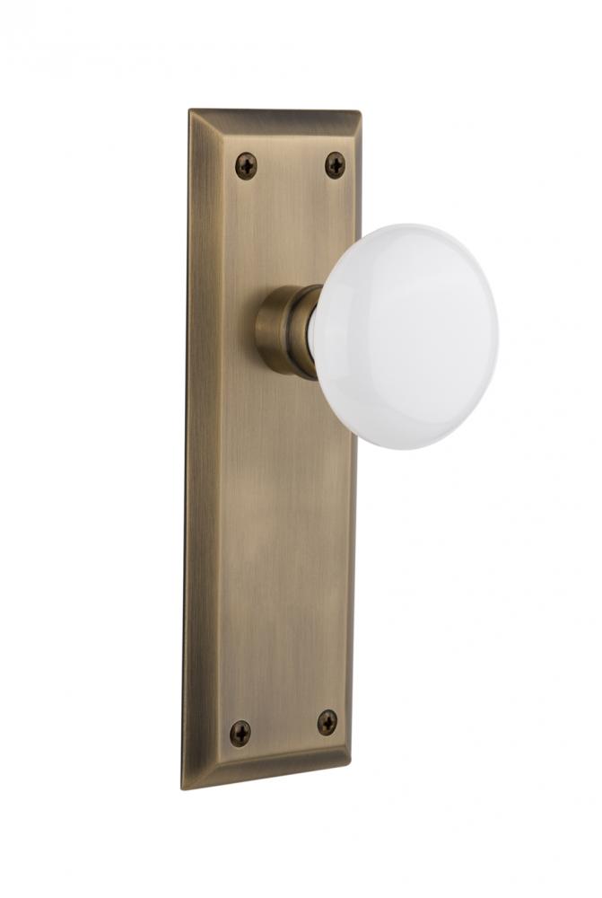 Nostalgic Warehouse New York Plate Privacy White Porcelain Door Knob in Antique Brass