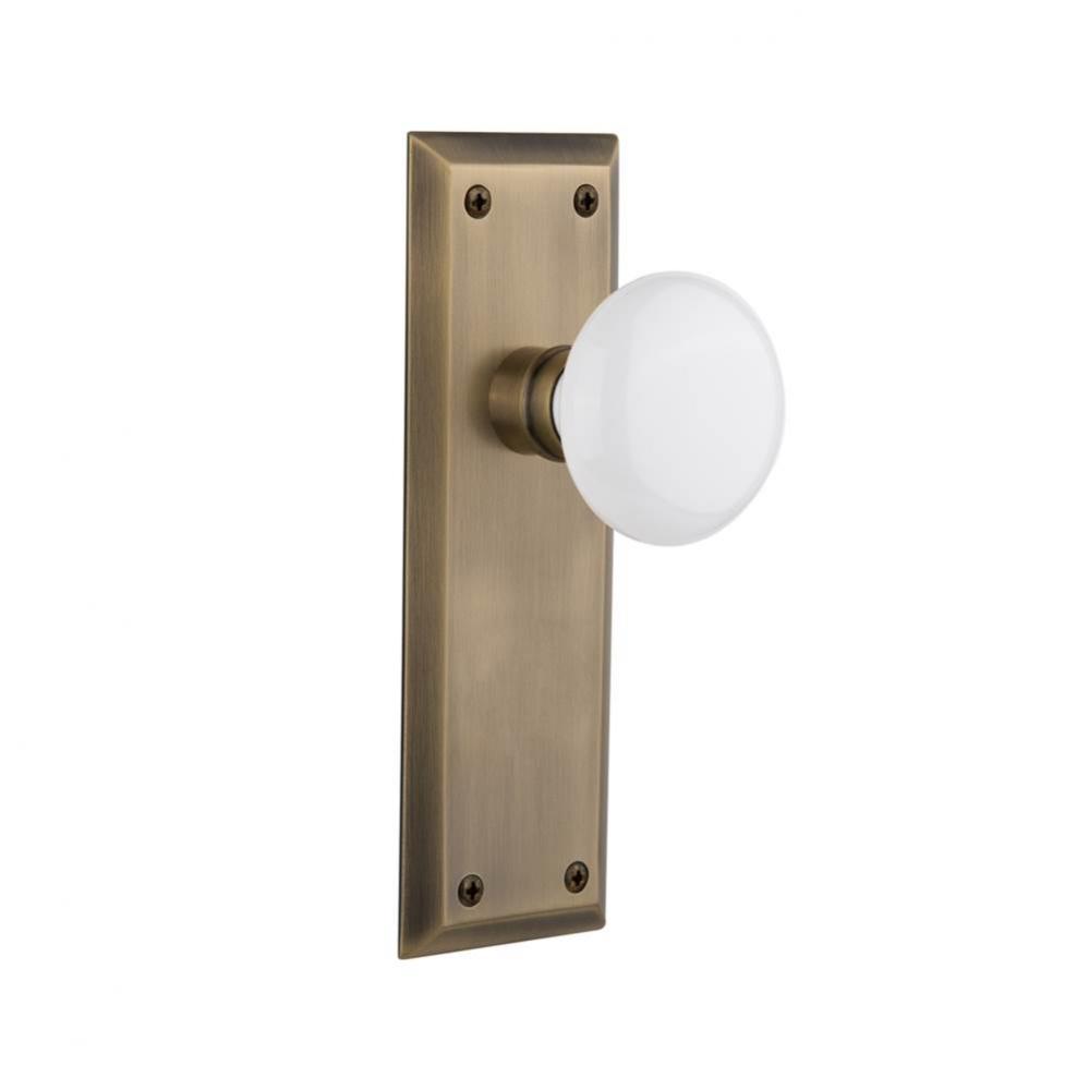 Nostalgic Warehouse New York Plate Privacy White Porcelain Door Knob in Antique Brass